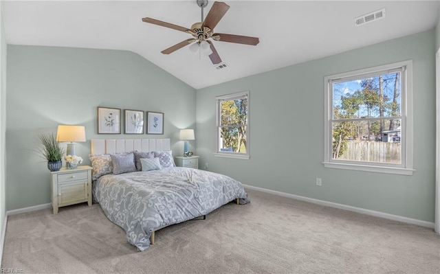 bedroom featuring light carpet, vaulted ceiling, and ceiling fan