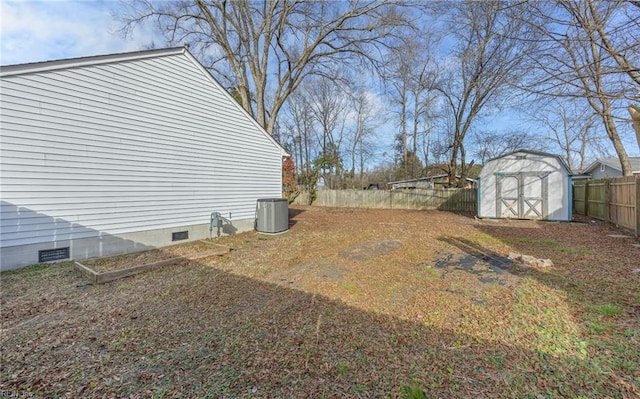 view of yard featuring a storage shed and central AC