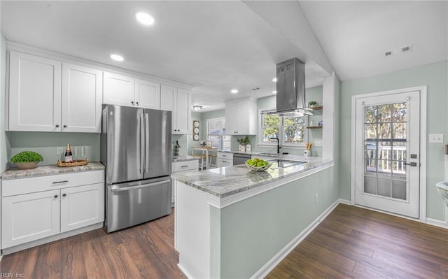 kitchen featuring white cabinetry, light stone countertops, kitchen peninsula, and appliances with stainless steel finishes