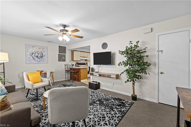 carpeted living room with ceiling fan