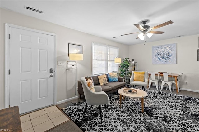 tiled living room featuring ceiling fan