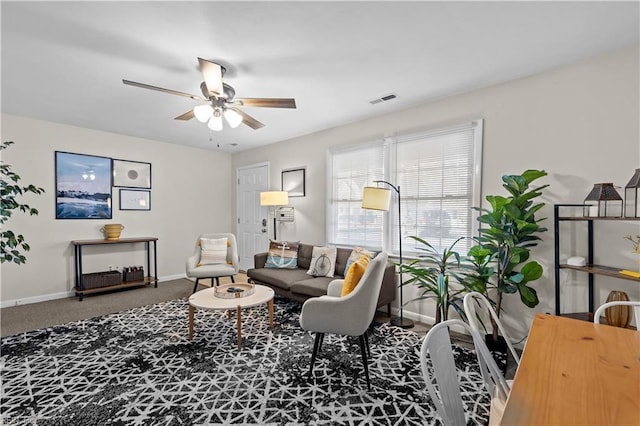 carpeted living room featuring ceiling fan