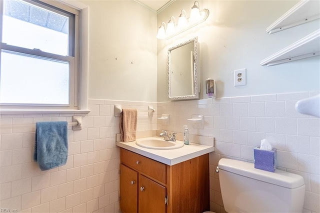 bathroom featuring vanity, tile walls, and toilet