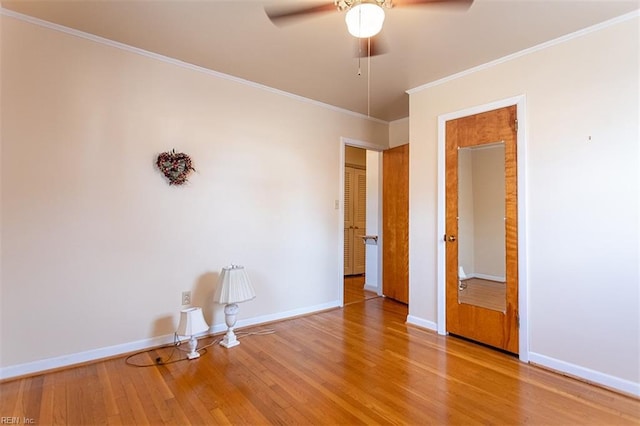 spare room with crown molding, hardwood / wood-style flooring, and ceiling fan