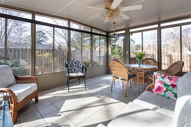 sunroom / solarium featuring ceiling fan