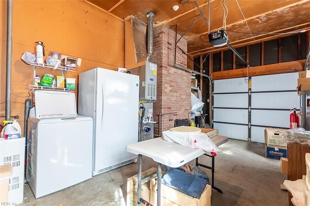 garage featuring white refrigerator, a garage door opener, and washer / dryer