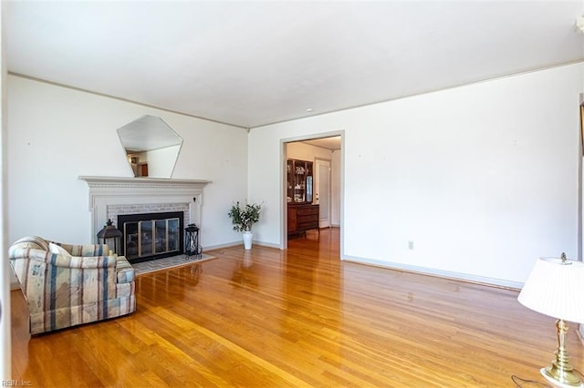 living room featuring hardwood / wood-style flooring and a brick fireplace