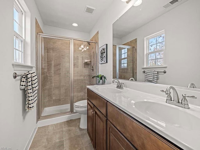 bathroom with vanity, toilet, tile patterned flooring, and a shower with door