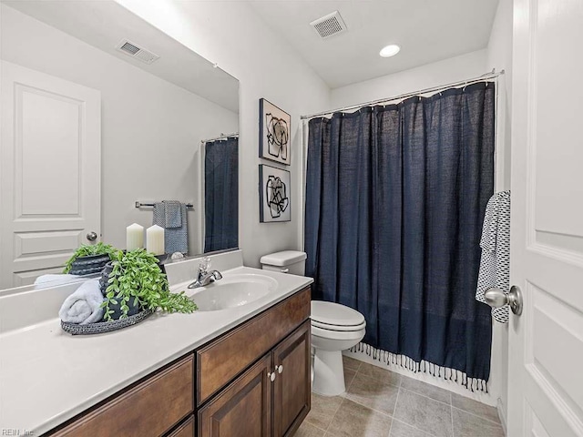 bathroom with vanity, tile patterned floors, and toilet