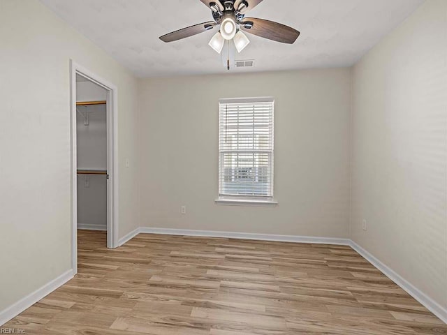 spare room featuring ceiling fan and light hardwood / wood-style floors