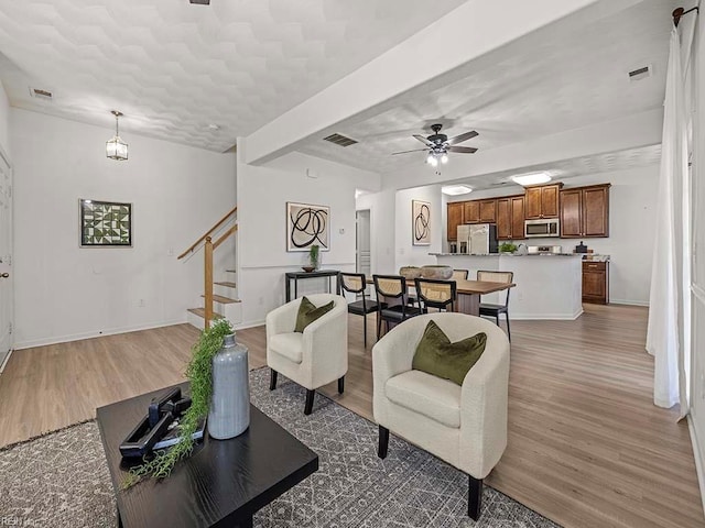 living room with dark wood-type flooring and ceiling fan