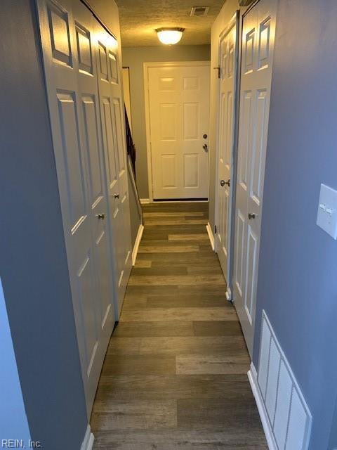 hallway featuring dark hardwood / wood-style flooring