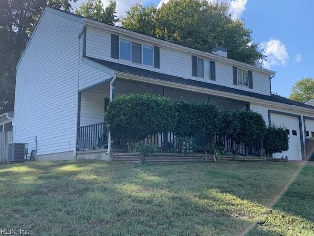 front facade featuring a garage, central AC unit, and a front lawn