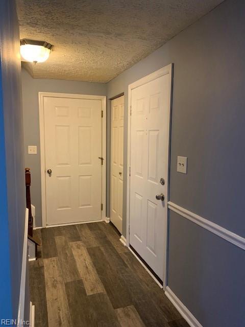 entryway featuring dark hardwood / wood-style floors and a textured ceiling