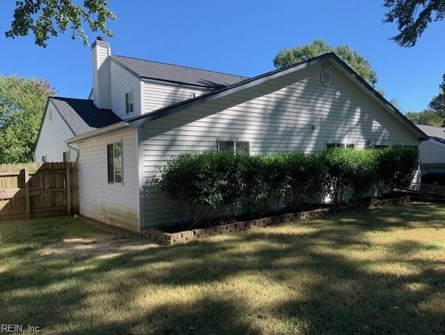 view of property exterior with a yard