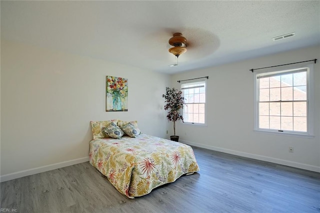 bedroom with hardwood / wood-style flooring and ceiling fan