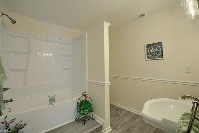 bathroom featuring hardwood / wood-style flooring and bathtub / shower combination