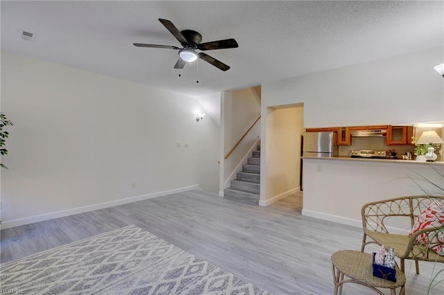 interior space with ceiling fan and light hardwood / wood-style flooring