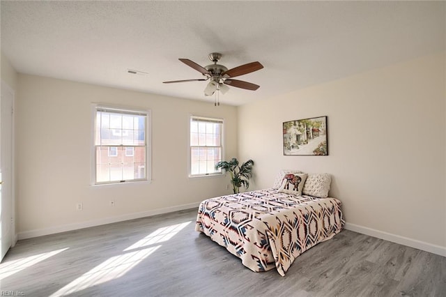 bedroom featuring ceiling fan and light wood-type flooring