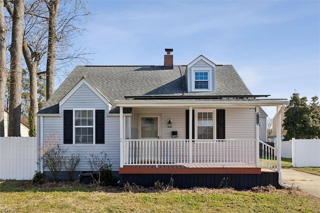 view of front of property with a front yard and covered porch