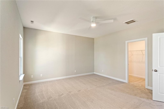 empty room featuring light carpet and ceiling fan