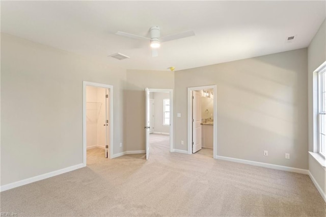 interior space featuring ceiling fan and light carpet