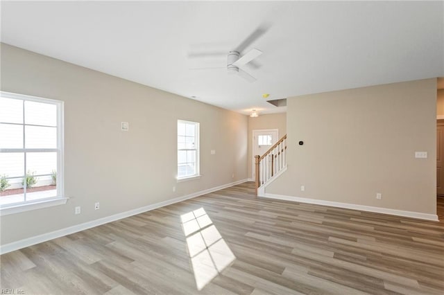 spare room with light hardwood / wood-style floors and ceiling fan