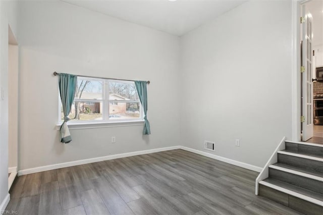 spare room featuring wood-type flooring