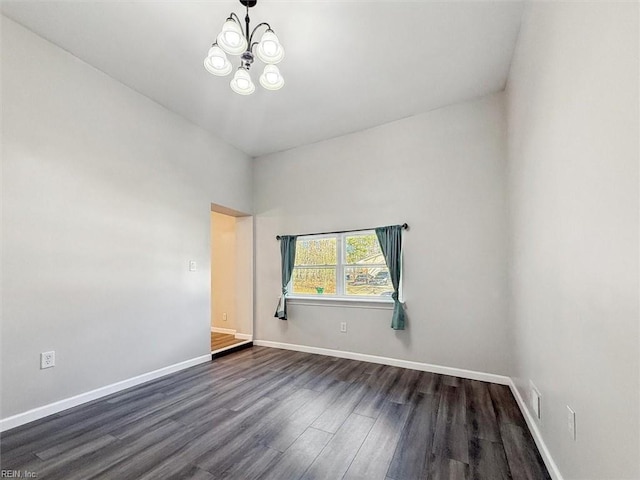 unfurnished room featuring dark hardwood / wood-style floors and a chandelier