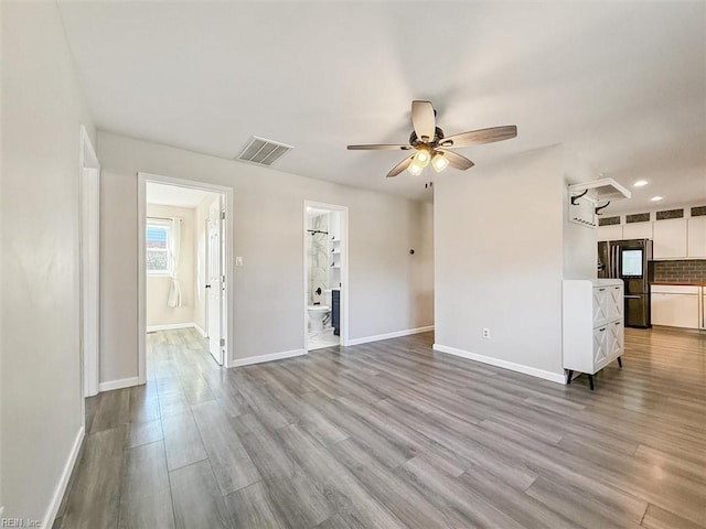 unfurnished living room featuring light hardwood / wood-style flooring and ceiling fan