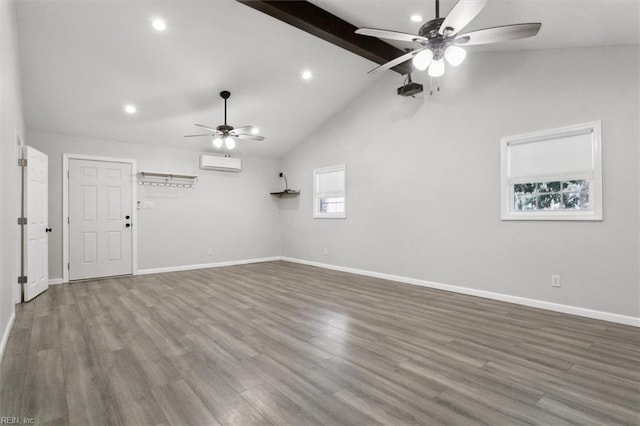 unfurnished room featuring vaulted ceiling with beams, hardwood / wood-style flooring, an AC wall unit, and ceiling fan