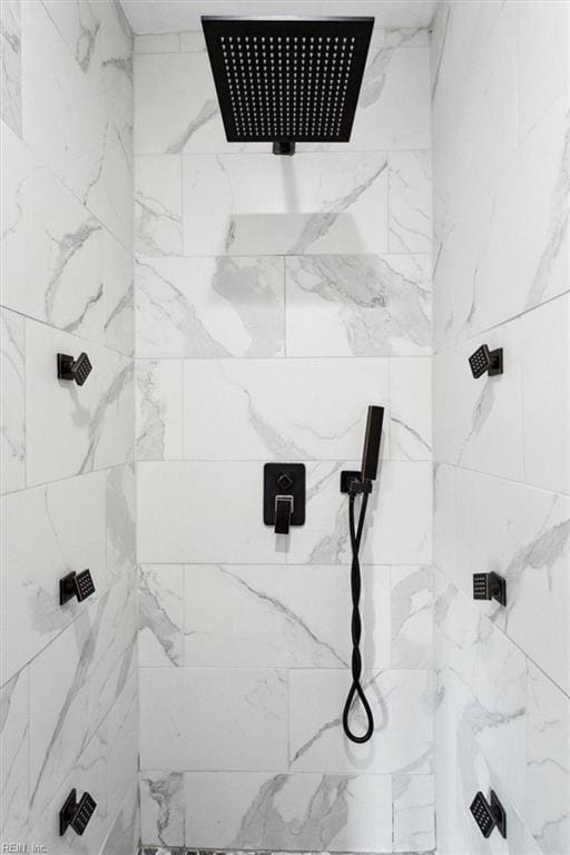 interior details featuring a tile shower