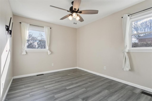 unfurnished room with ceiling fan, a healthy amount of sunlight, and hardwood / wood-style floors