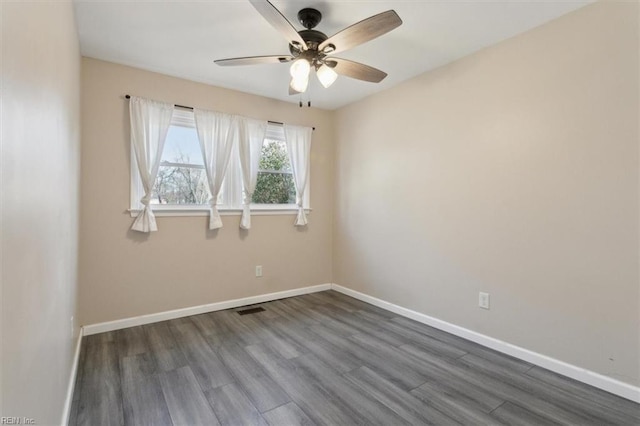 unfurnished room with dark wood-type flooring and ceiling fan