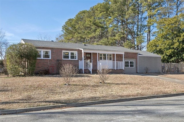 ranch-style home with a front yard and covered porch