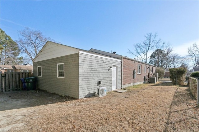 view of side of home with cooling unit and ac unit