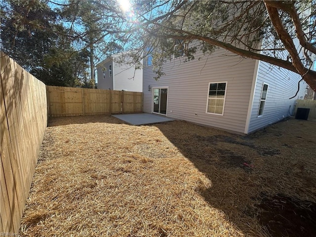 rear view of property with central AC unit and a patio area