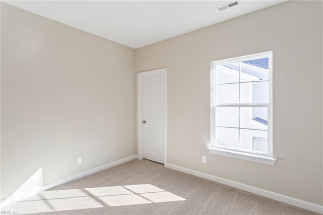 unfurnished room with light carpet and a wealth of natural light