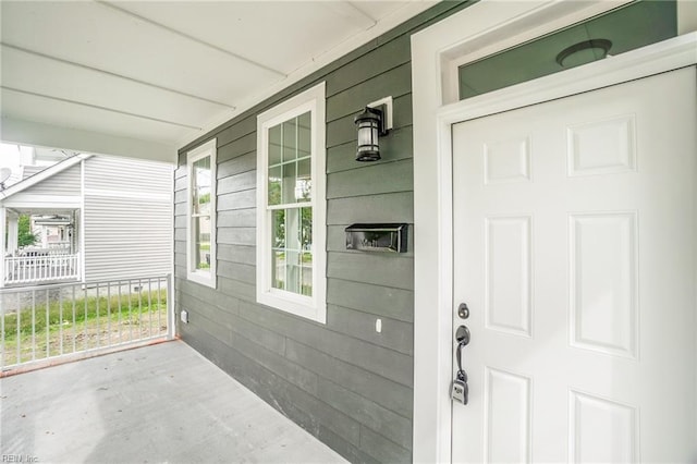 doorway to property featuring covered porch