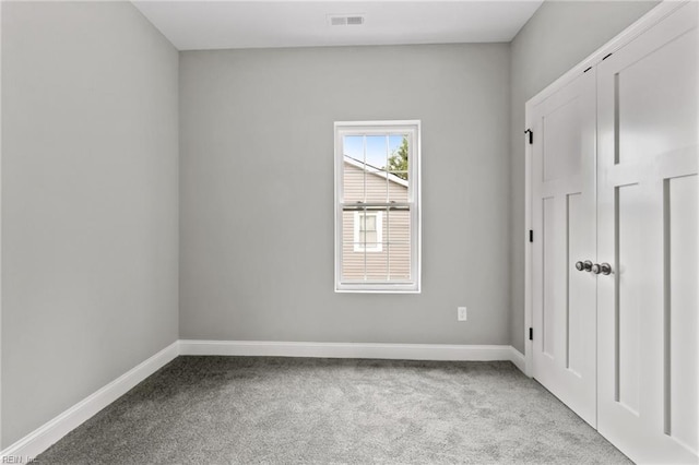 unfurnished room with light colored carpet