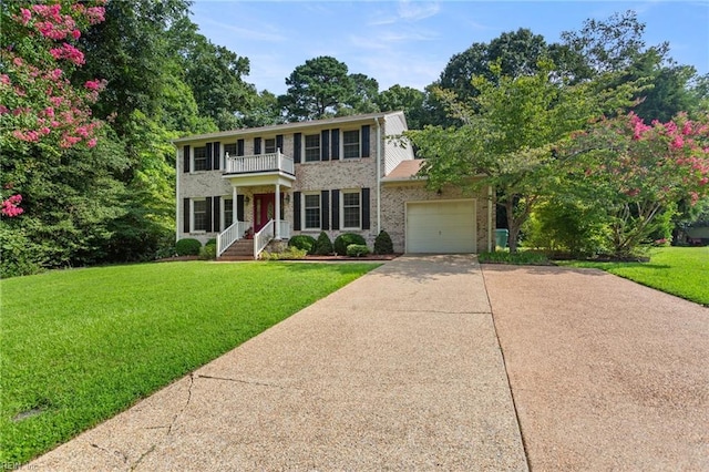 colonial home with a balcony, a garage, and a front lawn