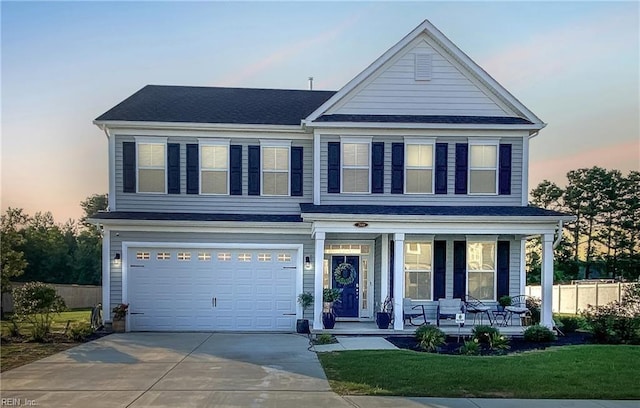 view of front of home with a porch and a garage