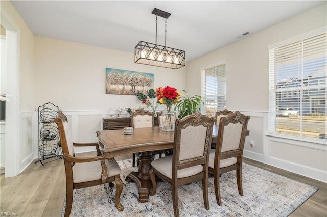 dining space with light hardwood / wood-style floors