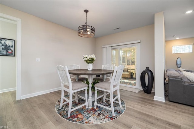 dining space with light hardwood / wood-style floors