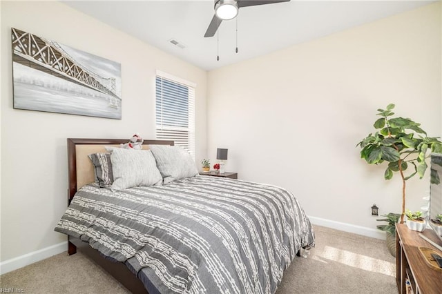 bedroom with light carpet and ceiling fan