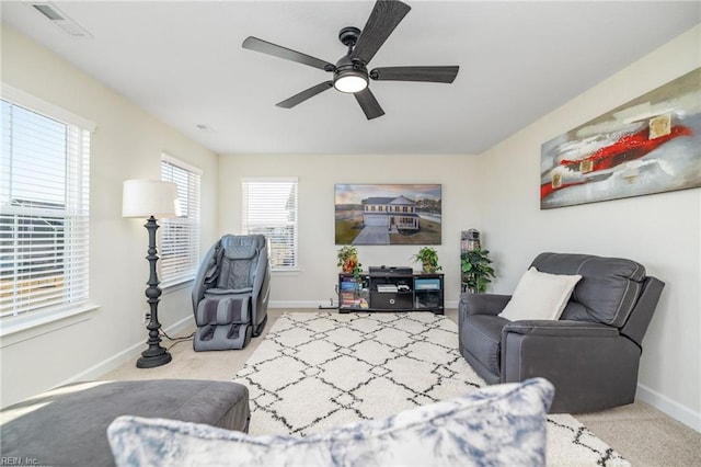 sitting room with light colored carpet and ceiling fan