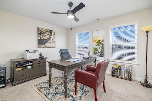 office space with light colored carpet and ceiling fan