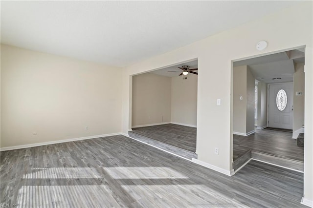 spare room with ceiling fan and wood-type flooring