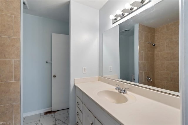 bathroom featuring vanity and a tile shower