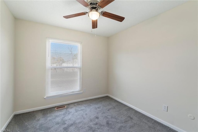 carpeted spare room with ceiling fan